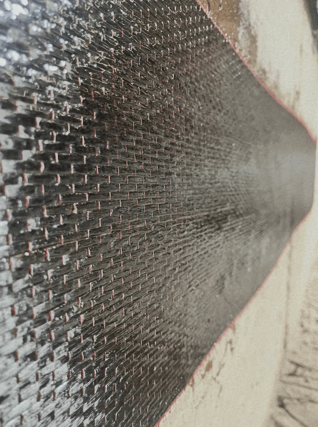 Close-up of carbon fibre reinforcement mesh applied for structural repair