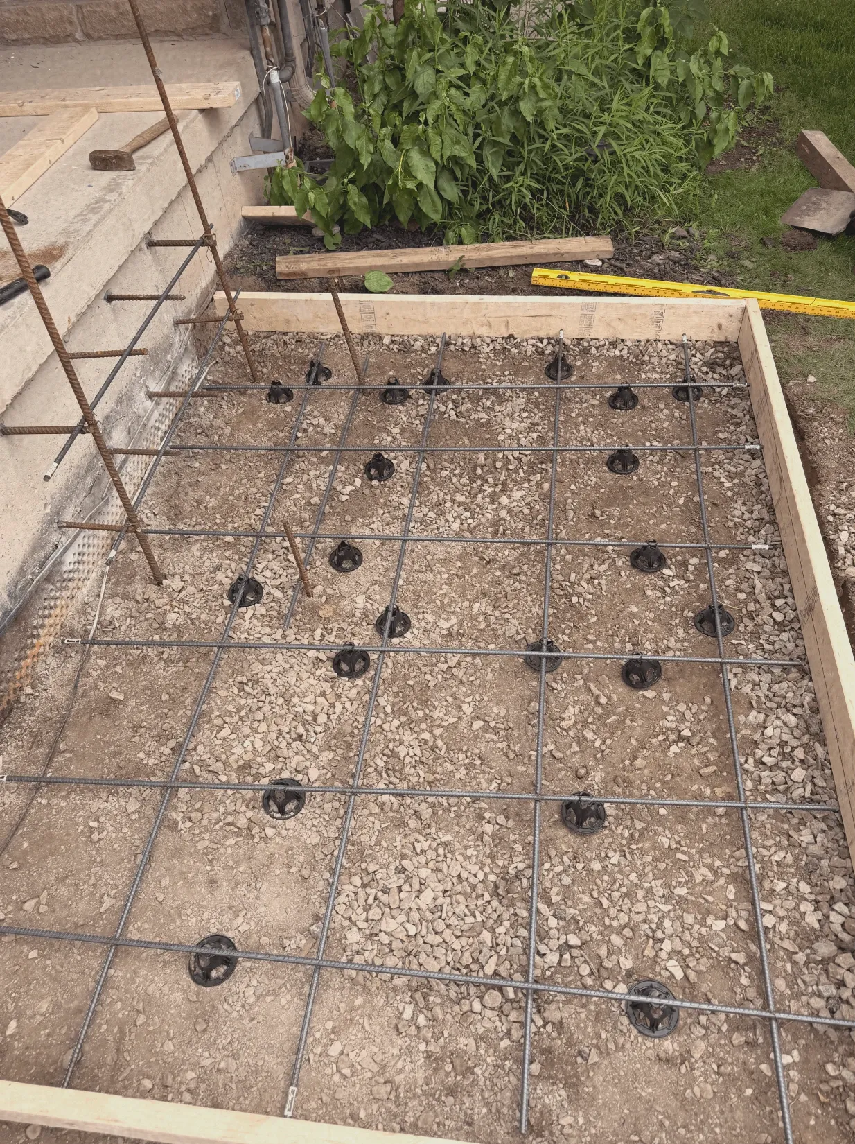 Rebar grid and gravel base prepped for a new concrete slab pour